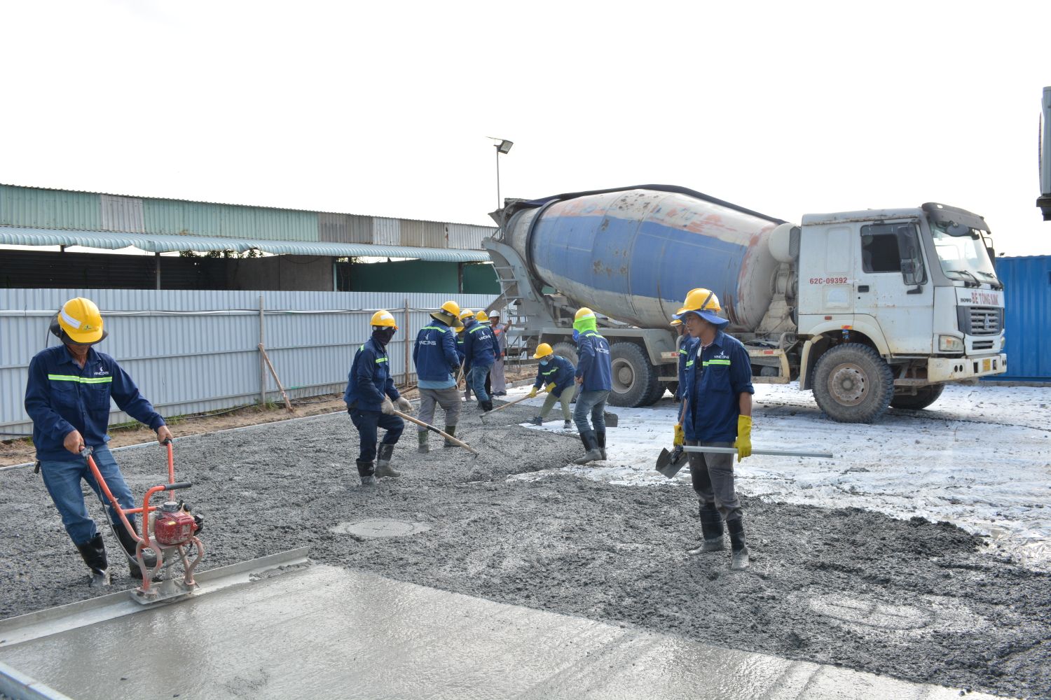 Ready mix concrete truck pouring liquid concrete into forms